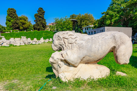 Ancient marble lion sculpture in sunny historical park setting. Authentic ancient Smyrna ruins in Izmir, Turkey.の写真素材