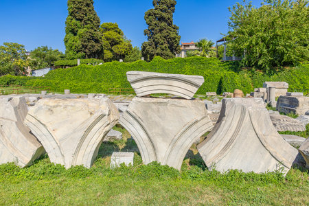 Ancient marble ruins in outdoor archaeological site with lush greenery. Authentic ancient Smyrna ruins in Izmir, Turkey.の写真素材