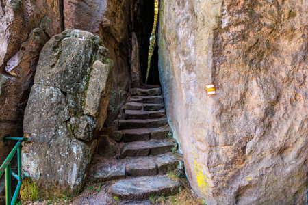 Stone stairway through narrow rocky passage with natural surroundings.の写真素材
