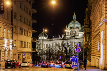 Historic night view of prague street with illuminated buildings and traffic. March 22, 2025 Prague Czechia.のeditorial素材