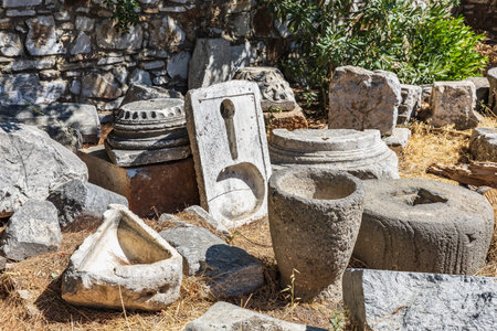 Ancient roman stone artifacts in sunlit outdoor archaeological site.の写真素材