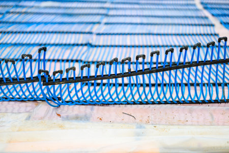 Blue cooling pipes fixed on concrete base for ice rink installation.の写真素材
