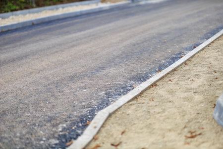 Freshly paved road with concrete borders.の写真素材