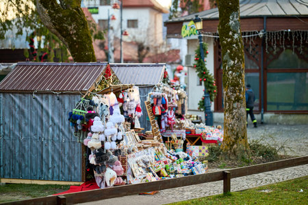 Outdoor holiday market with festive stalls displaying toys and decorations. December 13, 2025 Sinaia Romania.のeditorial素材