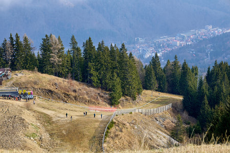 A ski slope at a ski resort in winter without snow. December 14, 2025 Sinaia Romania.のeditorial素材