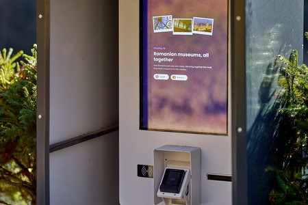 Interactive romanian museum kiosk with touchscreen display in outdoor setting. December 13, 2025...