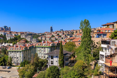 Urban cityscape with residential buildings and greenery under clear blue sky. August 12, 2025 Istanbul Turkey.のeditorial素材