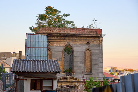 Abandoned historic building with overgrown vegetation at sunset. August 10, 2025, Istanbul Turkey.のeditorial素材