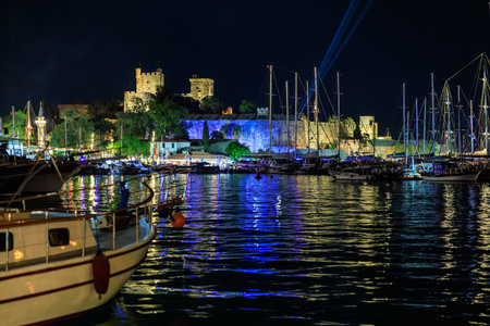 Night view of bodrum castle and marina with illuminated water reflections. August 5, 2025, Bodrum Turkey.のeditorial素材