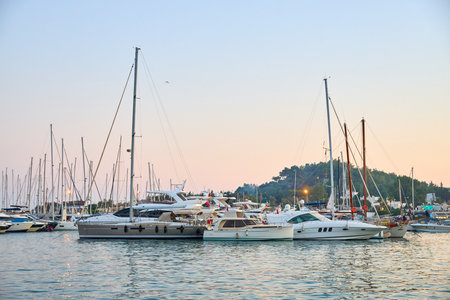 Sunset at marina with docked luxury yachts and sailboats in serene harbor. August 6, 2025, Bodrum...