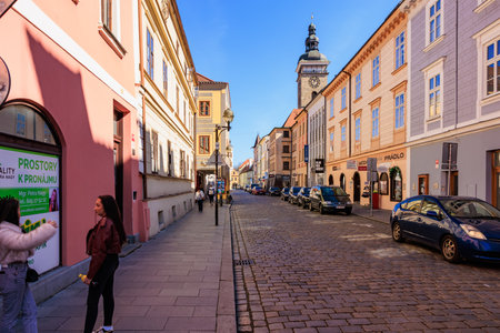 Sunny cobblestone street in historical european town with architectural details. March 21, 2025,...