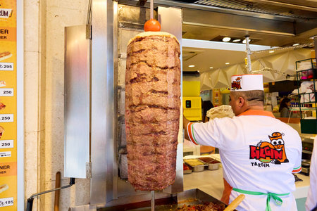 Street vendor preparing large doner kebab. August 11, 2025, Istanbul Turkey.のeditorial素材