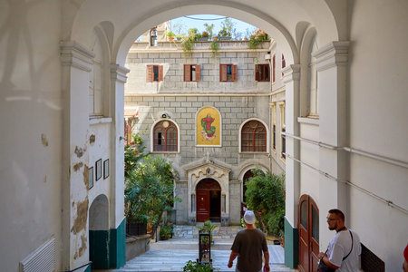 Historic courtyard with male visitors in urban setting. August 11, 2025, Istanbul Turkey.