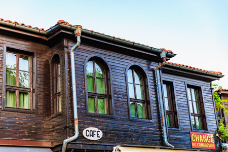 Rustic wooden building with cafe sign in urban setting.の写真素材
