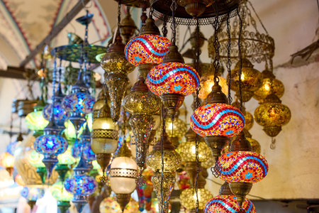 Vibrant mosaic lanterns in traditional market setting.