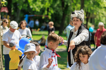 Outdoor childrens event with female guide in wolf hat. May 22, 2025 Balti Moldova.のeditorial素材