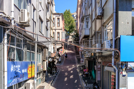 Narrow urban alley with buildings and graffiti in sunny weather. August 12, 2025 Istanbul Turkey.のeditorial素材
