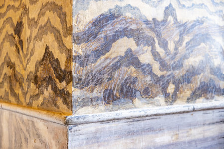 Marble corner with brown and gray swirls in interior design.