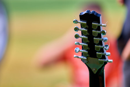 Close-up of guitar neck with blurred background.