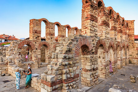 Ancient roman ruins in nessebar with visitors exploring stone arches. August 1, 2025, Nessebar...