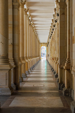 Elegant classical architecture with majestic columns in sunlit corridor.