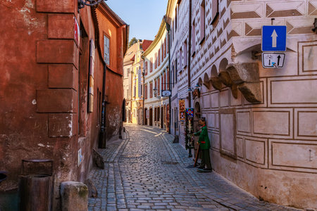 Historic european cobblestone street with colorful buildings in sunlight. March 20, 2025, Cesky...