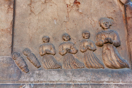 Ancient bas-relief of figures praying: historical stone carving of human figures. March 17, 2025, Konopiste Castle, Czech Republic.のeditorial素材