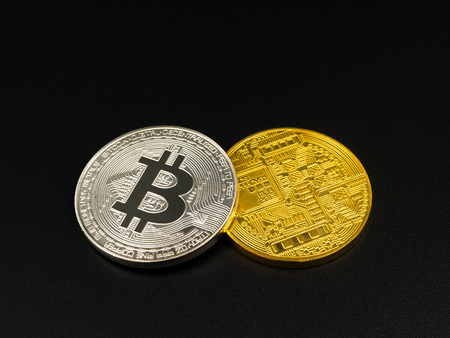 Golden and silver bitcoin on black background. Bitcoin cryptocurrencyの写真素材