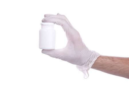 right hand holds a white packaging for tabletsの写真素材