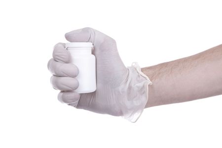 right hand shaking a white packaging for tablets の写真素材