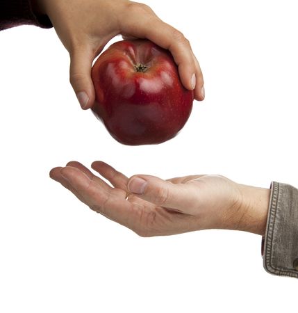 woman's hand gives a red apple man's hand,macroの写真素材