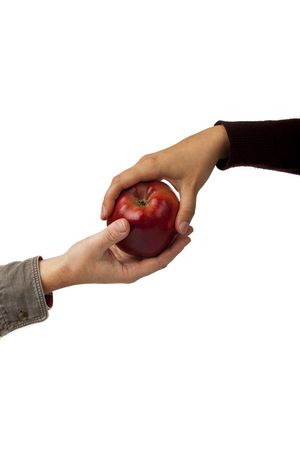 woman's hand gives a red apple man's handの写真素材