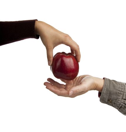woman's hand gives a red apple man's hand,white backgroundの写真素材