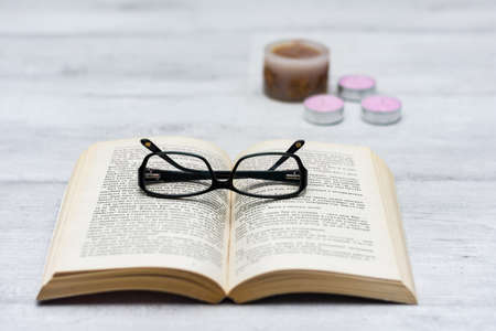 Open book and reading glassesの写真素材