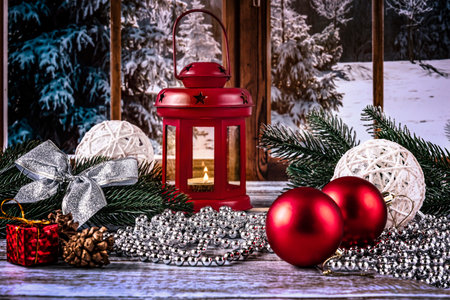 Christmas decoration with red lantern and Christmas tree branches on wooden background.の写真素材