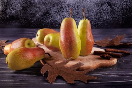 Ripe pears and autumn leaves on a wooden background. selective focus.の写真素材