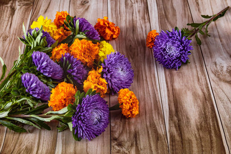 Autumn bouquet of asters and marigolds on a wooden background. Hello autumn, back to school. view from above.の写真素材