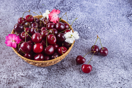 Cherries in a basket on a concrete background. selective focus.の写真素材
