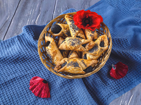 Basket of cookies with poppy seed cookies on a blue napkin.の写真素材