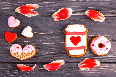 Valentine's day cookies and tulip petals on wooden backgroundの写真素材