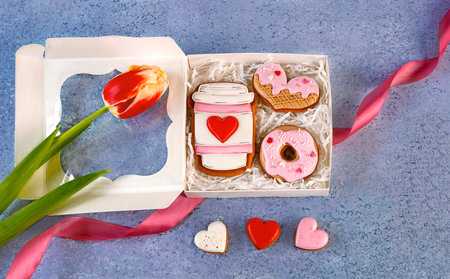 Valentines day gift box with gingerbread cookies and tulip on blue backgroundの写真素材