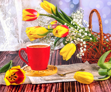 Cup of coffee and bouquet of tulips on wooden backgroundの写真素材