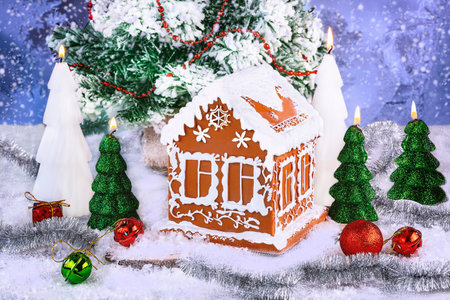 Gingerbread house and Christmas tree on snow, on bright backgroundの写真素材