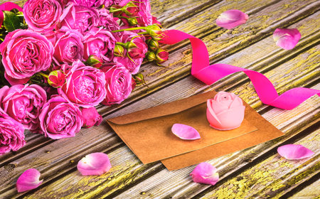 Valentines day greeting card with pink roses on wooden background.の写真素材