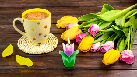 Cup of cappuccino with tulips on wooden backgroundの写真素材