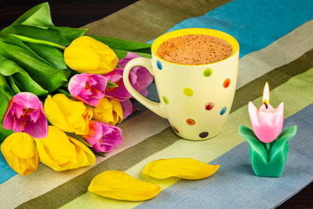 Cup of coffee and tulips on a wooden background. Selective focus.の写真素材