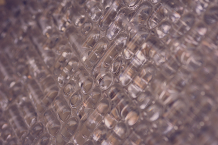 Background texture corrugated glass, pattern. Close-up, selective focus, side view, copy space.