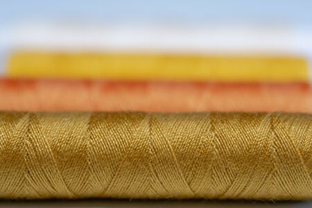 Colorful spools of thread form a beautiful rainbowの写真素材