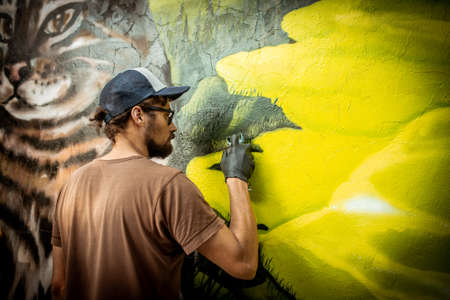 street artist spray paint on the wall on "Street Art Week" festival on July 18, 2019 in Novokuznetsk, Kemerovo Region, Russian Federation.のeditorial素材