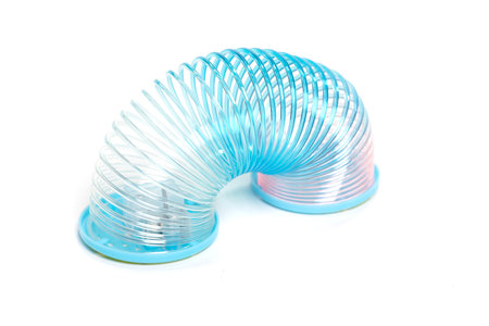 Toy plastic colorful rainbow spiral for play isolated on whiteの写真素材